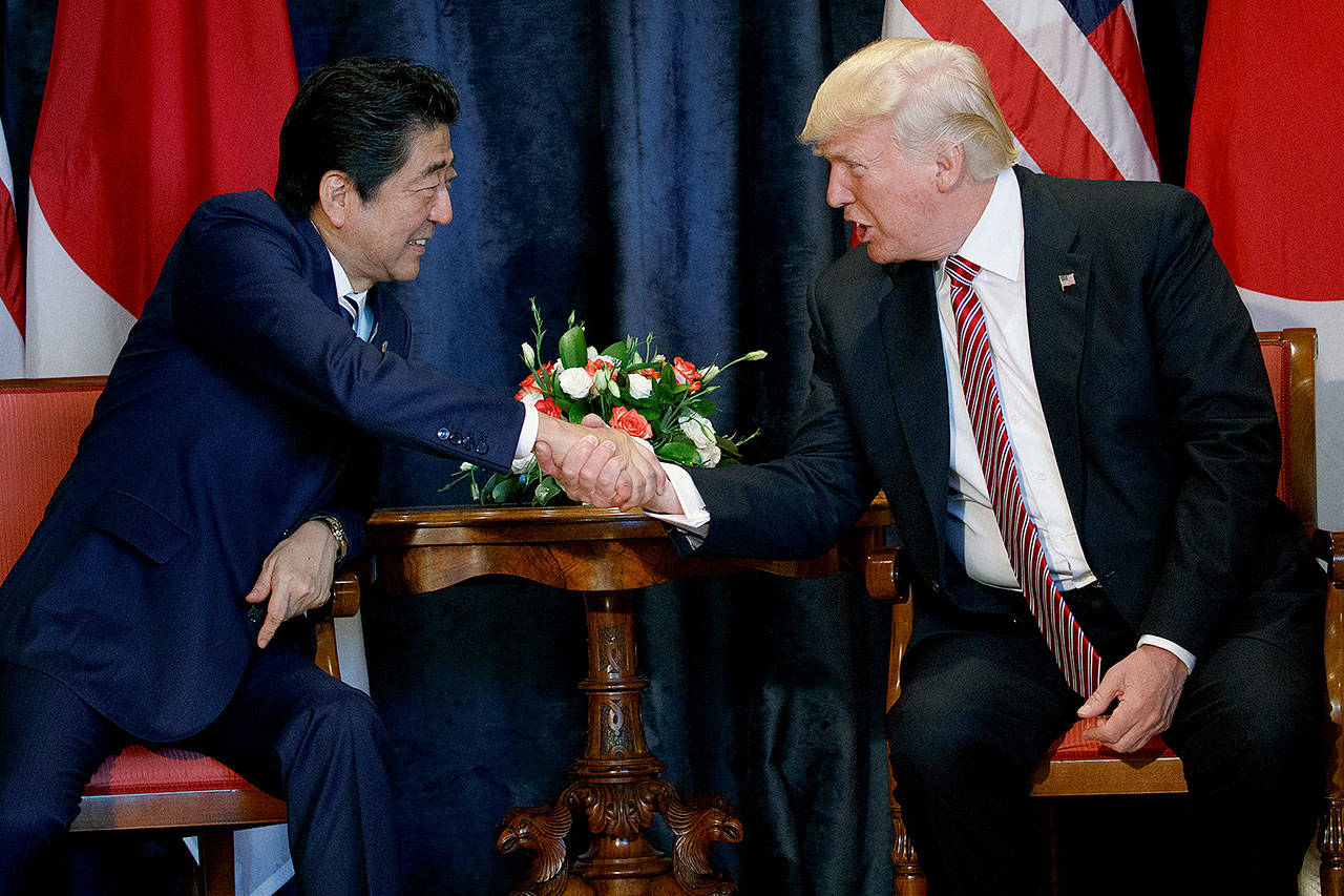 President Donald Trump (right) shakes hands with Japanese Prime Minister Shinzo Abe during a meeting at the G7 Summit on Friday in Taormina, Italy. (AP Photo/Evan Vucci)