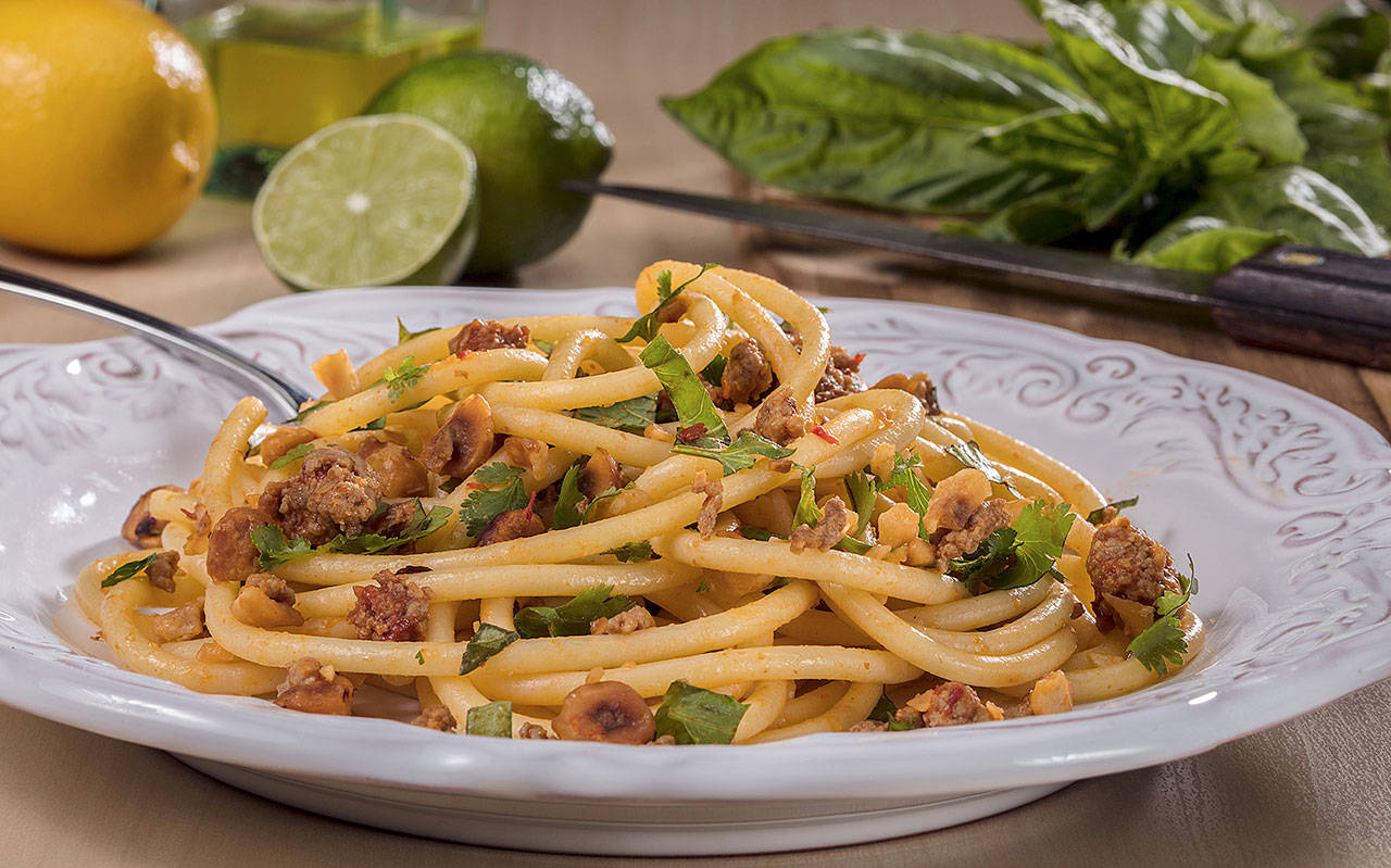 Bucatini, a long, spaghetti-like noodle with a hole running through the length of it, is tossed with hazelnuts, red pepper paste, lamb and fresh herbs. (Photo by Zbigniew Bzdak/Chicago Tribune)