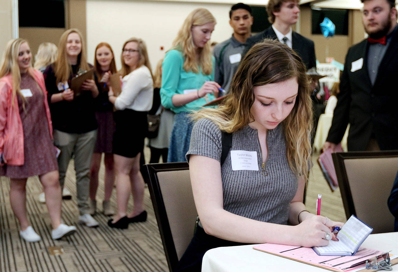 Memorial High School senior Taylor Wicks figures which life insurance plan to purchase during the Eau Claire Area Chamber of Commerce’s Real Life Academy at the Lismore Hotel in Eau Claire, Wisconsin, earlier this year. It helps to know the basics if you’re thinking about buying life insurance. (Marisa Wojcik / The Eau Claire Leader-Telegram)