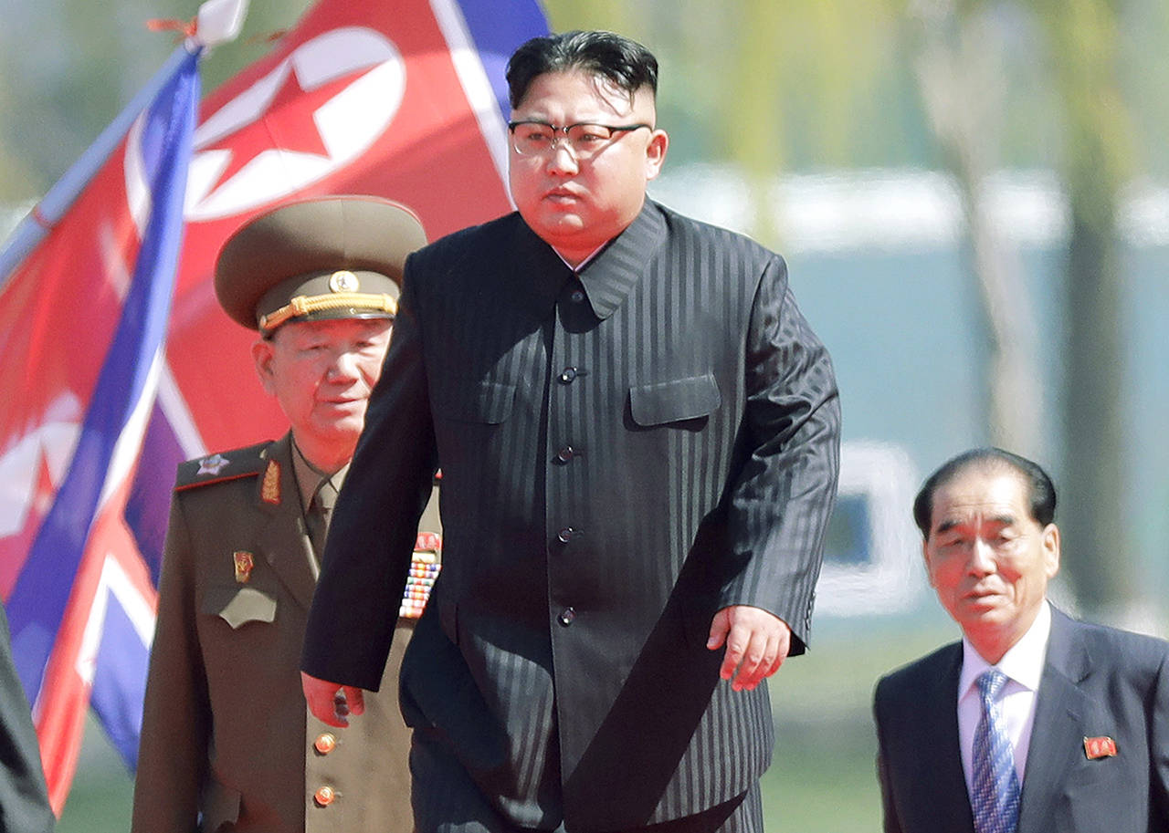 In this April 13 photo, North Korean leader Kim Jong Un center is accompanied by Pak Pong Ju (right) and Hwang Pyong So as he arrives for the official opening of the Ryomyong residential area in Pyongyang, North Korea. (AP Photo/Wong Maye-E, File)