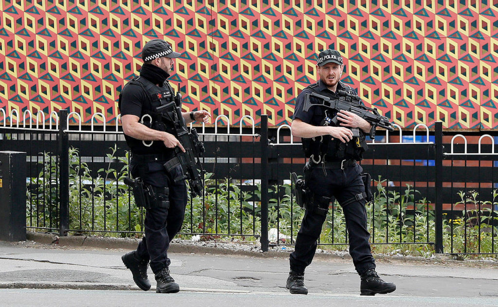 Armed police guard Victoria Station in Manchester, England, on Wednesday. (AP Photo/Kirsty Wigglesworth) 

