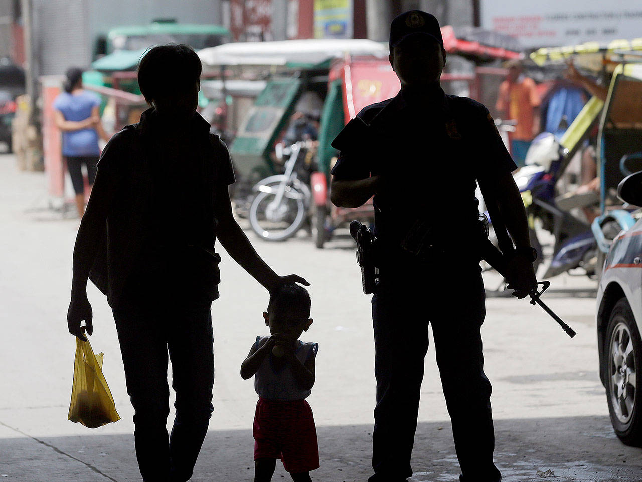 A policeman stands at a checkpoint in Manila, Philippines, on Wednesday after the Philippine National Police was placed under full alert status following the declaration of martial law in Mindanao. (AP Photo/Aaron Favila)