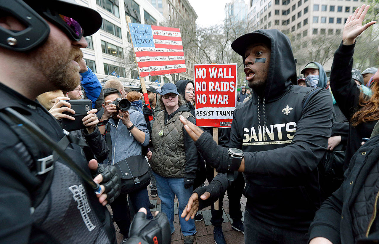 Protesters argue during a May Day protest on Monday in Seattle. (AP Photo/Ted S. Warren)