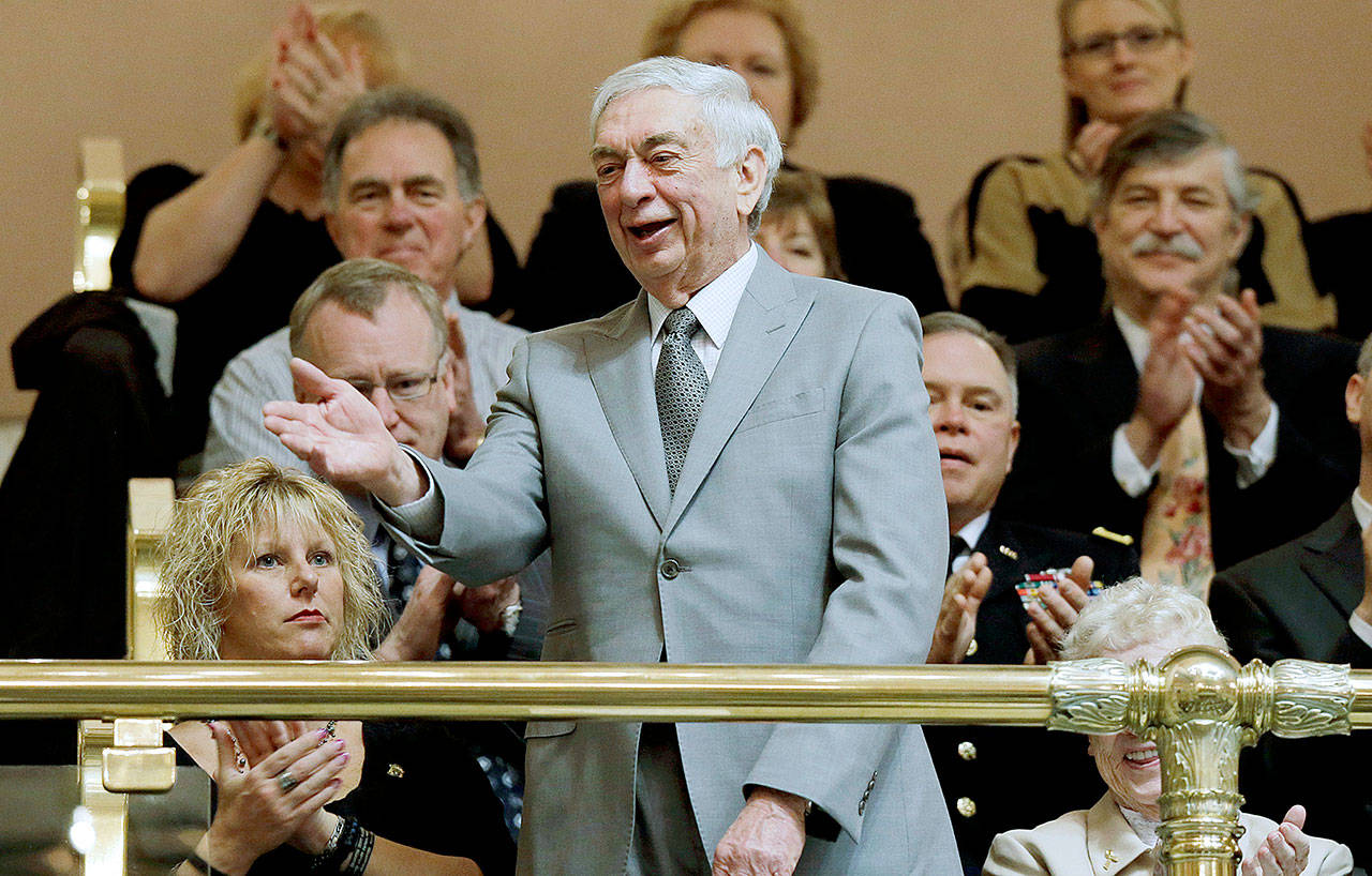 Former Washington Gov. Mike Lowry is introduced from the gallery in the state House chamber before Gov. Chris Gregoire’s final State of the State speech to a joint session of the Legislature at the Capitol in Olympia in 2013. (AP Photo/Ted S. Warren, File)