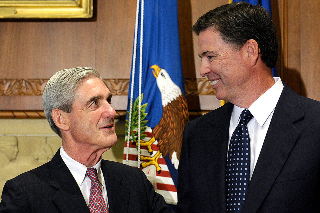 Then-incoming FBI Director James Comey (right) talks with outgoing FBI Director Robert Mueller in 2013 before Comey was officially sworn in at the Justice Department in Washington. (AP Photo/Susan Walsh, File)