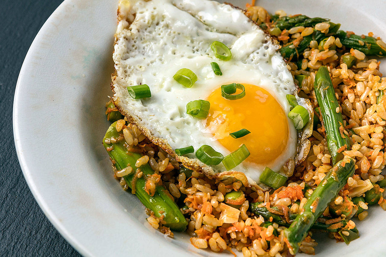 Fried rice can be healthful when made with spring vegetables, eggs and sesame seeds. (Photo by Goran Kosanovic for The Washington Post)