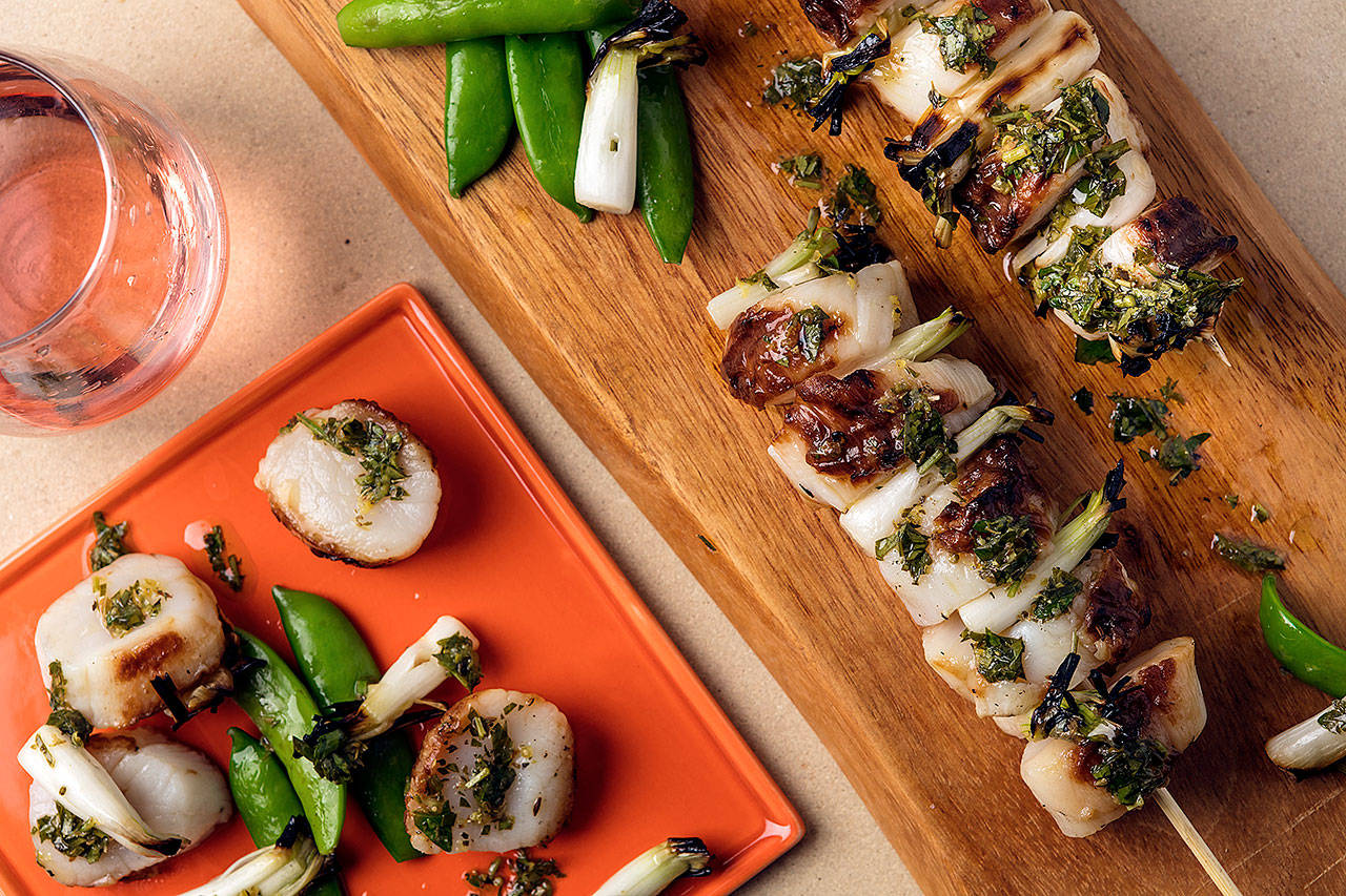Grilled scallops drizzled with a classic Mediterranean combination of lemon, extra-virgin olive oil and herbs. (Photo by Goran Kosanovic for The Washington Post)