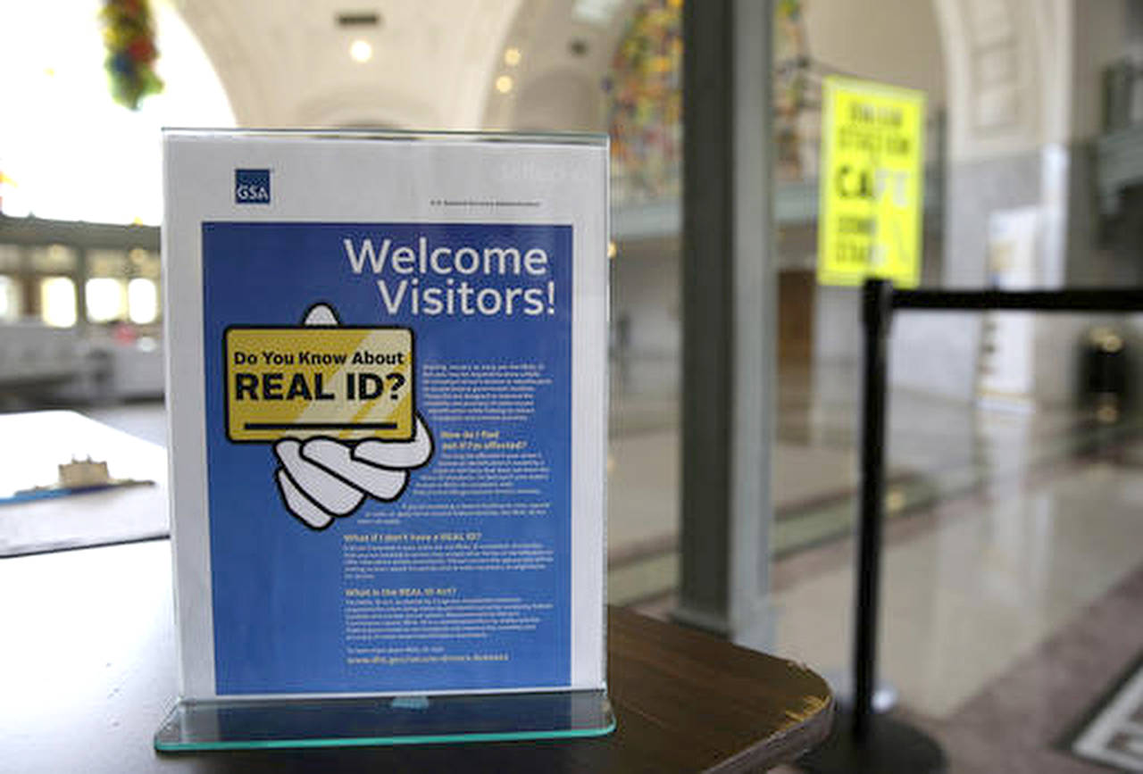 In this 201 photo, a sign at the federal courthouse in Tacoma is shown to inform visitors of the federal government’s REAL ID act, which requires state driver’s licenses and ID cards to have security enhancements and be issued to people who can prove they’re legally in the United States. (AP Photo/Ted S. Warren, File)