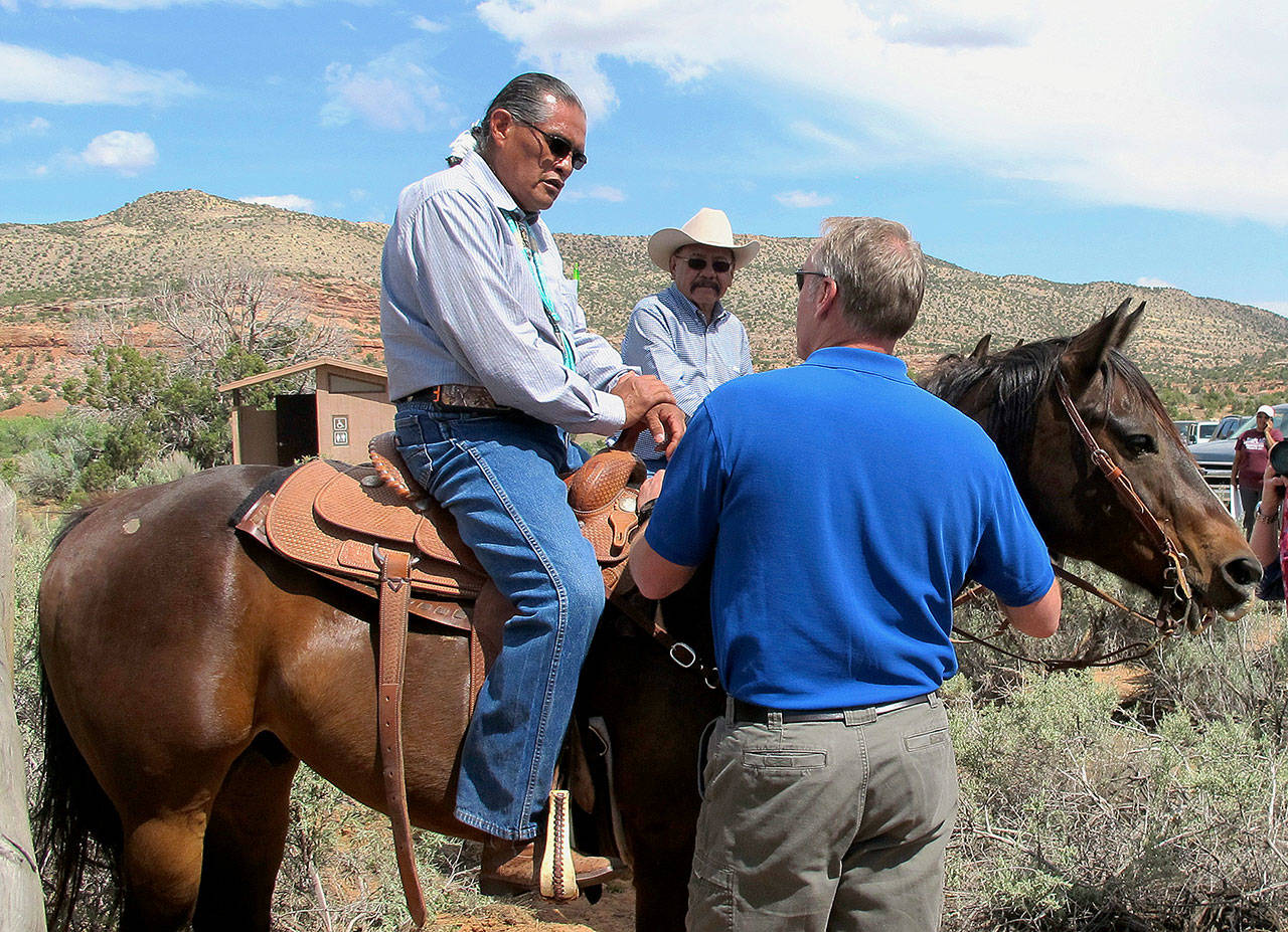 Interior Secretary Ryan Zinke (right) talks with two men on horses on Monday at the Butler Wash trailhead in Bears Ears National Monument near Blanding, Utah. (AP Photo/Michelle Price)