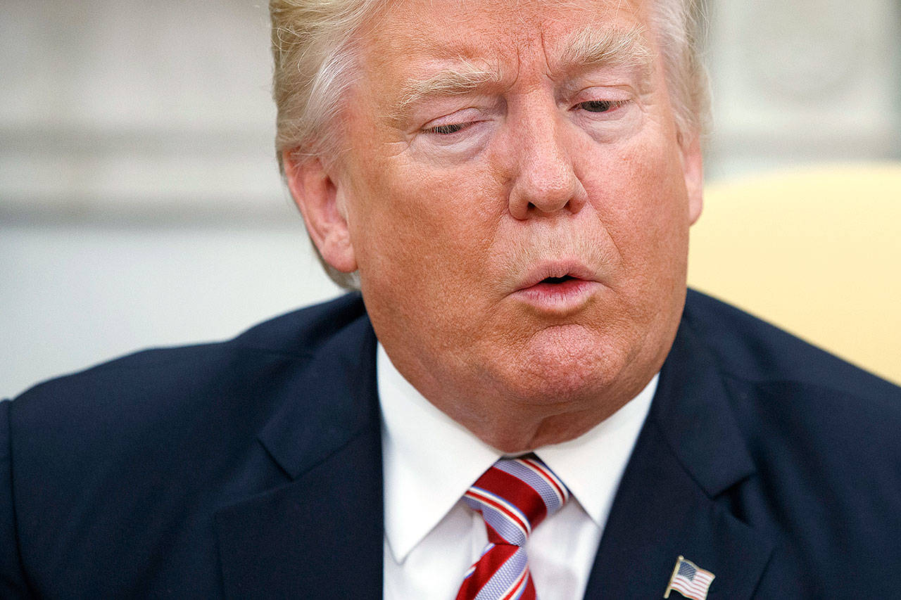 President Donald Trump talks to reporters in the Oval Office of the White House on Wednesday in Washington. (AP Photo/Evan Vucci)