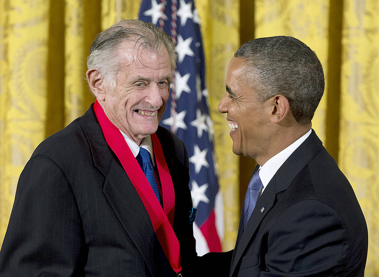 In this July 2013 photo, President Barack Obama laughs with Frank Deford as he awards him the 2012 National Humanities Medal during a ceremony in the East Room of White House in Washington. (AP Photo/Carolyn Kaster, File)