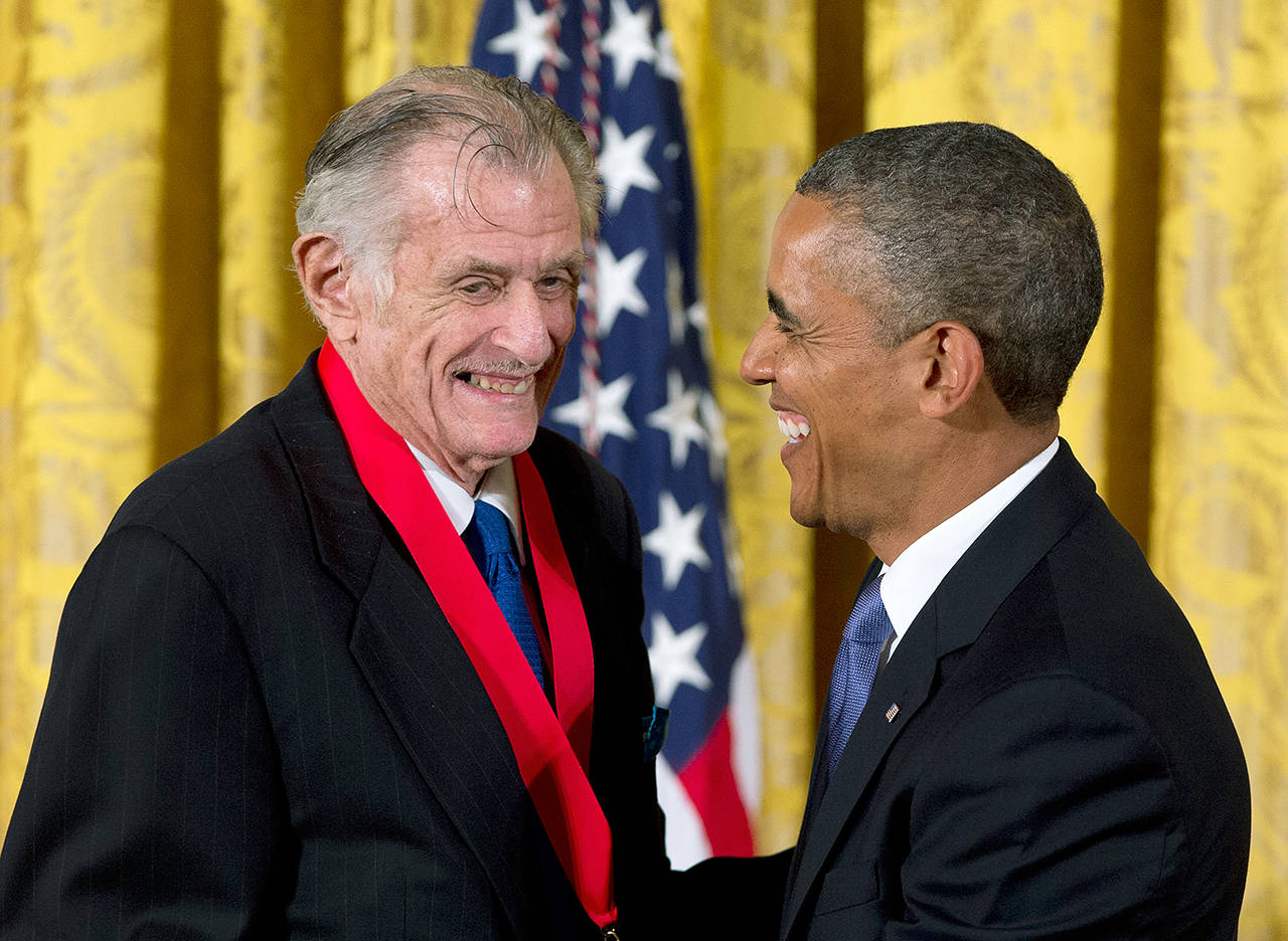 President Barack Obama laughs with Frank Deford as he awards him the 2012 National Humanities Medal during a ceremony in the East Room of White House in Washington on July 10, 2013. The award-winning sports writer and commentator passed away Sunday in Key West, Florida. He was 78. (AP Photo/Carolyn Kaster, File)