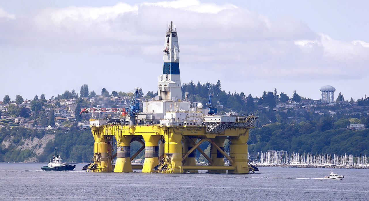 In this May 2015 photo, the oil drilling rig Polar Pioneer is towed toward a dock in Elliott Bay in Seattle. (AP Photo/Elaine Thompson, File)