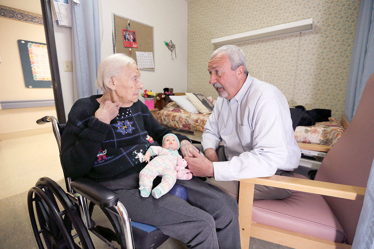 Glen Hotchkiss talks to his mother, Phyllis Hotchkiss, at her nursing home in Adrian, Michigan, in April 2016. Phyllis Hotchkiss, 93, has dementia and is confined to a wheelchair and was involuntarily discharged from her nursing home this year to one further away from her family. (Associated Press)