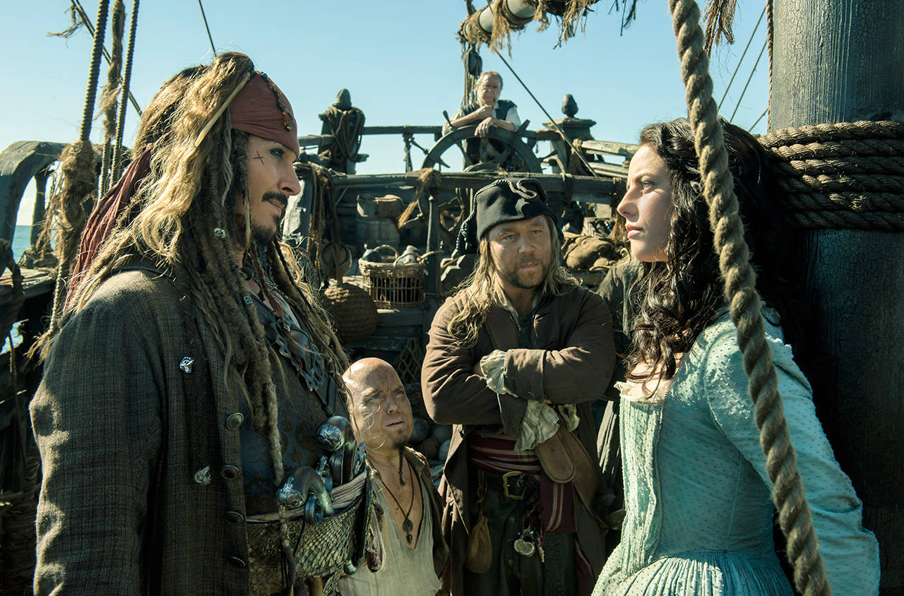 In this image released by Disney, Johnny Depp portrays Jack Sparrow and Kaya Scodelario portrays Carina Smyth in a scene from “Pirates of the Caribbean: Dead Men Tell No Tales.” (Peter Mountain/Disney via AP)
