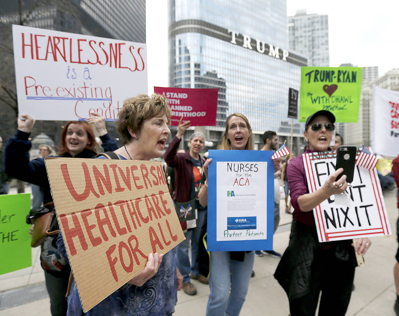 In March 24 photo, protesters gather across the Chicago River from Trump Tower to rally against the repeal of the Affordable Care Act, in Chicago. (AP Photo/Charles Rex Arbogast, File)