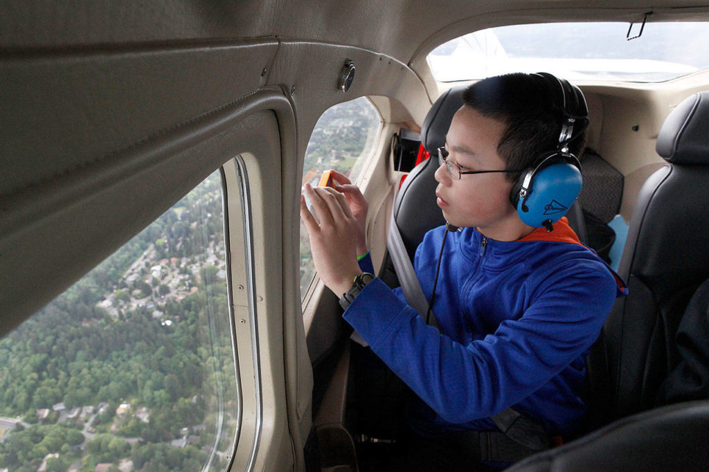 Tom Bodin takes a free ride in a Cessna 182 Skylane during Aviation Day at Paine Field in 2014. This year’s event is set for May 20. (Herald file photo)
