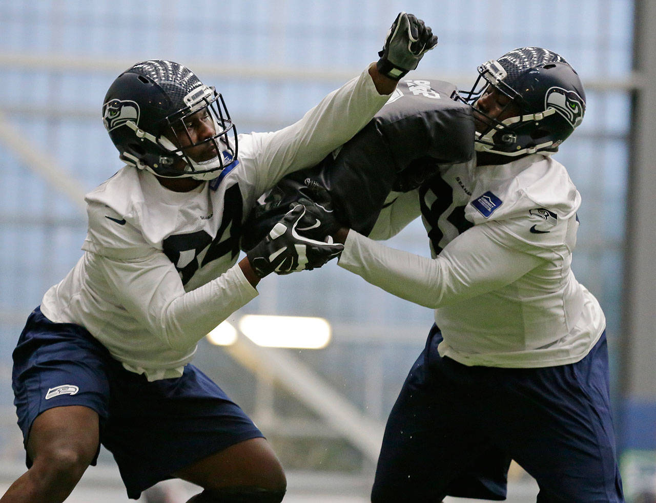 Seahawks defensive tackles Malik McDowell (left) and Jeremy Liggins take part in a drill during rookie minicamp on May 12, 2017, in Seattle. (AP Photo/Ted S. Warren)