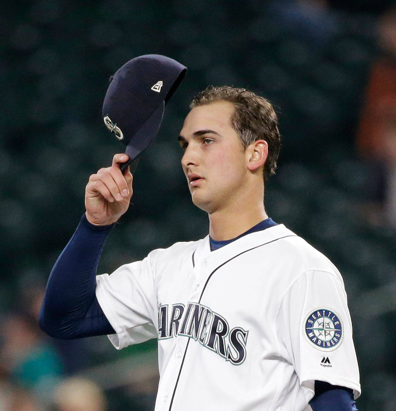 Mariners starting pitcher Chase De Jong adjusts his cap before throwing a pitch during a game against the Athletics on May 16, 2017, in Seattle. (AP Photo/Elaine Thompson)
