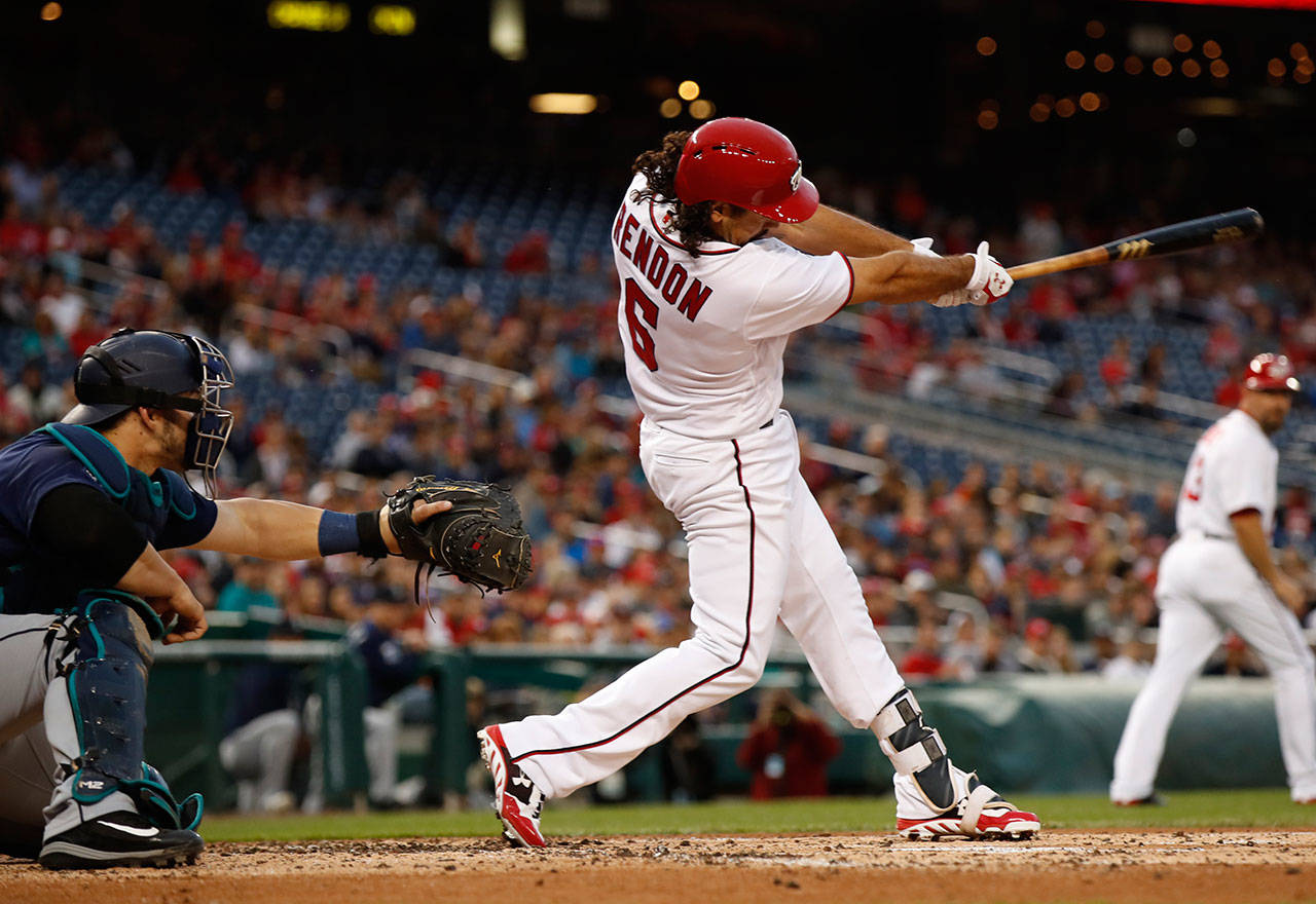 Washington Nationals third baseman Anthony Rendon (6), swings and hits a three-run home run during the first inning of a game against the Mariners on May 24, 2017, in Washington. Mariners catcher Mike Zunino (left) watches. (AP Photo/Manuel Balce Ceneta)