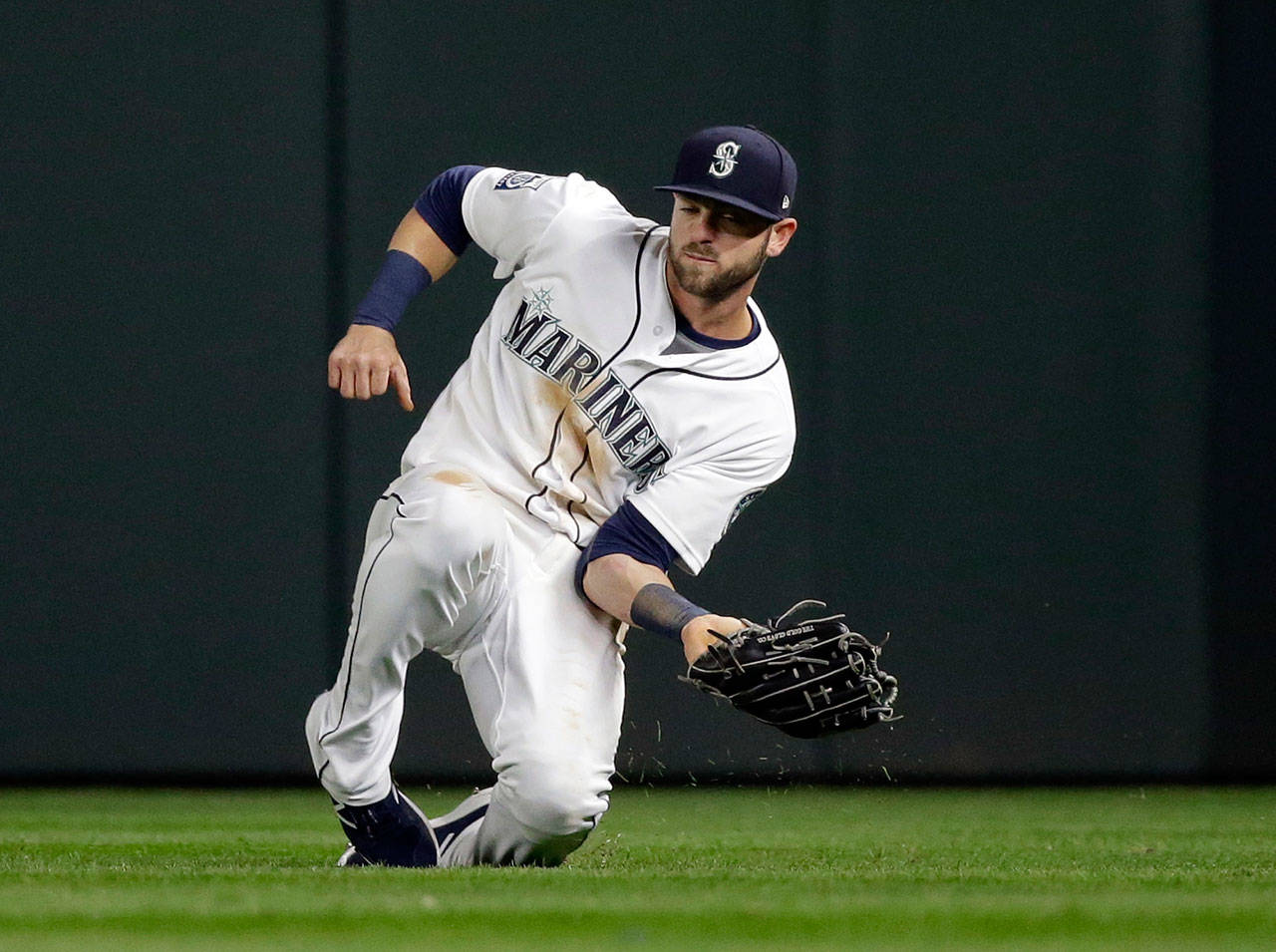 Mariners right fielder Mitch Haniger makes a sliding catch during a game against the Astros on April 12, 2017, in Seattle. (AP Photo/Elaine Thompson)
