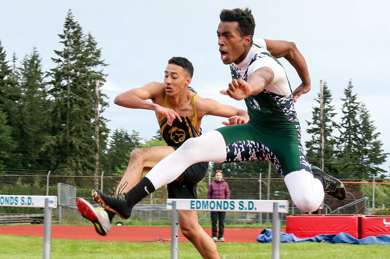 Edmonds-Woodway’s Aaron Richardson (right) races past Lynnwood’s Elijah Edwards to win the 300-meter hurdles during the Wesco 3A South track and field championships on May 12, 2017, at Edmonds Stadium. (Kevin Clark / The Herald)