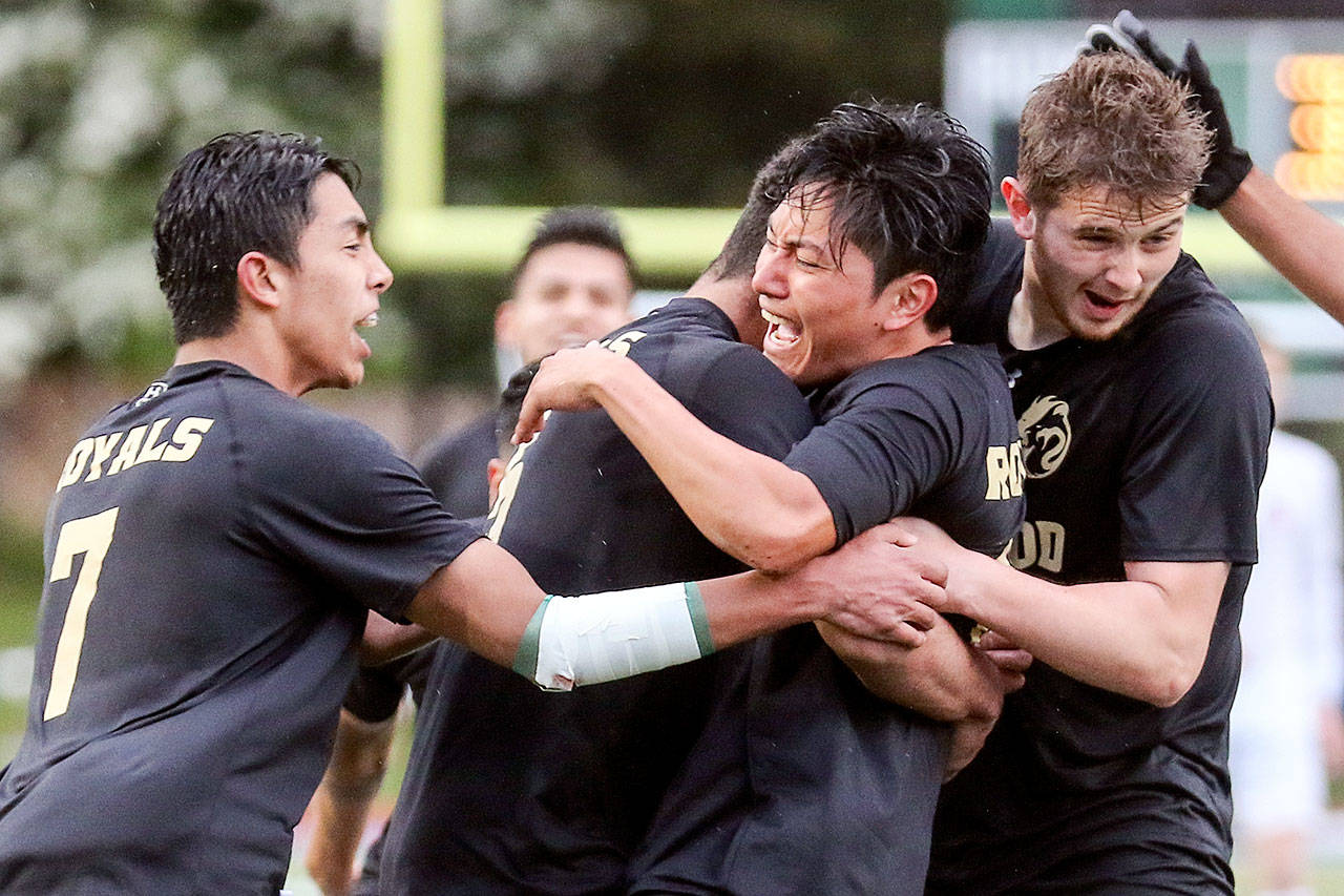 Lynnwood’s Patrick Kreider (front right) celebrates his match-tying goal with his teammates during the Royals’ 4-1 win over Snohomish for the 3A District 1 championship Saturday in Shoreline. (Kevin Clark / The Herald)