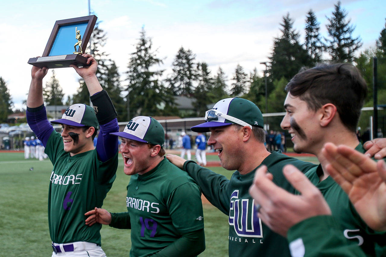 Edmonds-Woodway celebrates its 3A District 1 tournament championship Saturday in Shoreline after beating Shorewood 2-1 behind the pitching of Nick Hull. (Kevin Clark / The Herald)