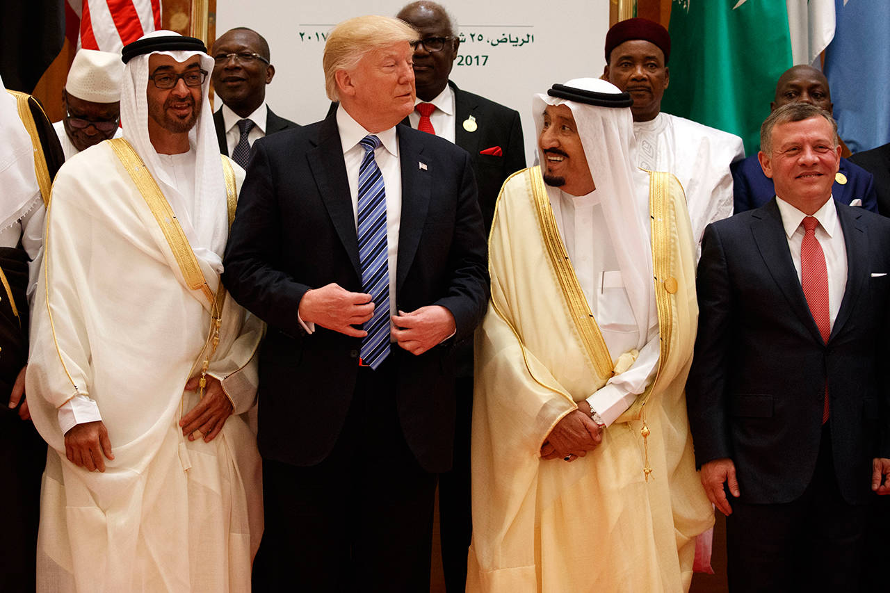 President Donald Trump talks with Saudi King Salman as they pose for photos with leaders at the Arab Islamic American Summit, at the King Abdulaziz Conference Center, Sunday, May 21, 2017, in Riyadh, Saudi Arabia. Jordan’s King Abdallah II stands at right. (AP Photo/Evan Vucci)