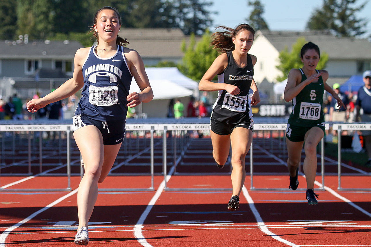 Kevin Clark / The Herald                                Sidney Trinidad of Arlington (left) crosses the finish line to win the 3A girls 100-meter hurdles final Friday at the state track and field championships at Mount Tahoma High School. Lynnwood’s Rita Sakharov (center) placed fourth and Shorecrest’s Marieke Visscher (right) was seventh.
