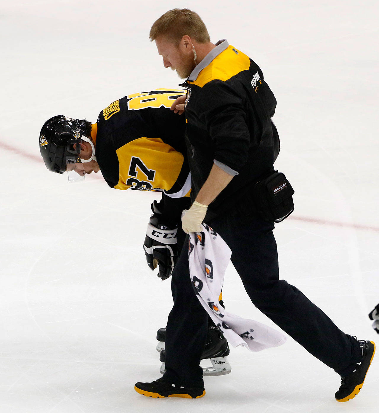 Pittsburgh’s Sidney Crosby (87) is helped off the ice after being injured during the first period of Game 3 of the Penguins’ NHL Stanley Cup Eastern Conference semifinal series against the Washington Capitals. (AP Photo/Gene J. Puskar)