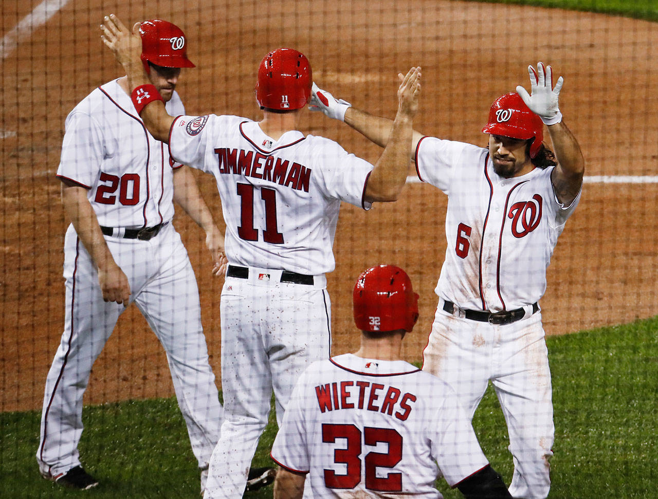 Anthony Rendon of the Washington Nationals (6) is congratulated by his teammates after hitting a three-run home run Tuesday against the Seattle Mariners. Rendon homered twice in the game. (AP Photo/Manuel Balce Ceneta)