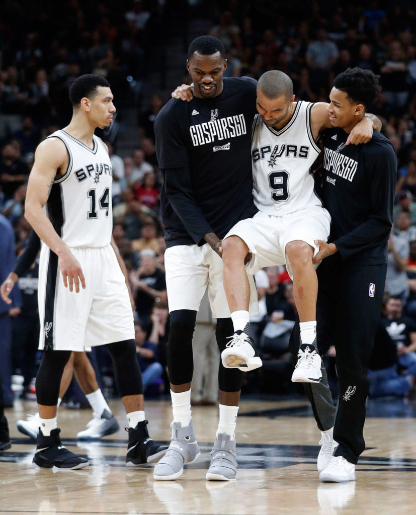 San Antonio Spurs guard Tony Parker (9) is carried off the court after suffering an injury in the fourth quarter of Wednesday night’s NBA playoff game against the Houston Rockets. (Karen Warren/Houston Chronicle via AP)

