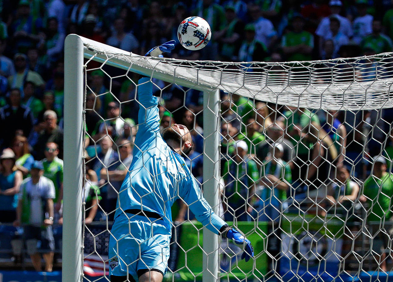 Seattle goalkeeper Stefan Frei leaps to tip a ball over the cross bar during the first half of the Sounders’ MLS match against the Portland Timbers on Saturday in Seattle. The Sounders won 1-0. (AP Photo/Ted S. Warren)