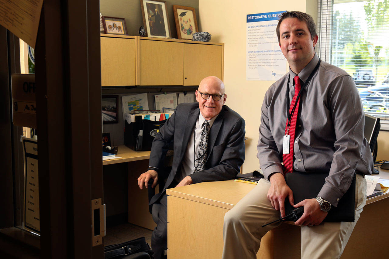 Michael Piper (right) assistant principal at Lynnwood High School, will become the principal for the next school year. Dave Golden, who is reaching retirement, is demoting himself to assistant. (Kevin Clark / The Herald)