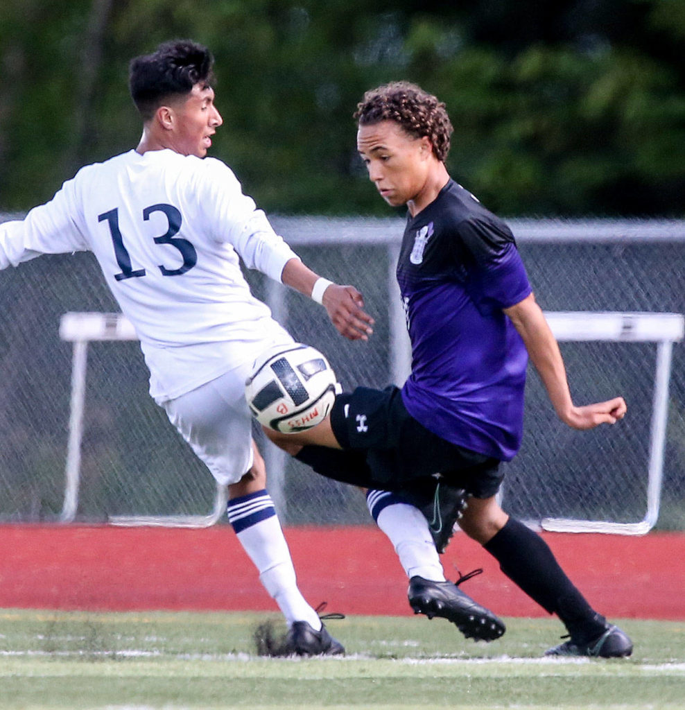 Kamiak’s Andre’ Hamilton controls the ball past Mariner’s Efren Martinez during a 4A district playoff game on May 13, 2017, in Lake Stevens. Kamiak won 2-1. (Kevin Clark / The Herald)
