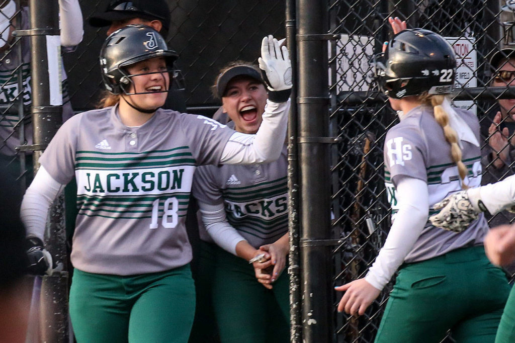 Jackson’s Kassidi Dean (left) celebrates a run scored by Sam Klotter during the 4A district championship game against Lake Stevens on May 18, 2017, at Phil Johnson Ballfields in Everett. (Kevin Clark / The Herald)
