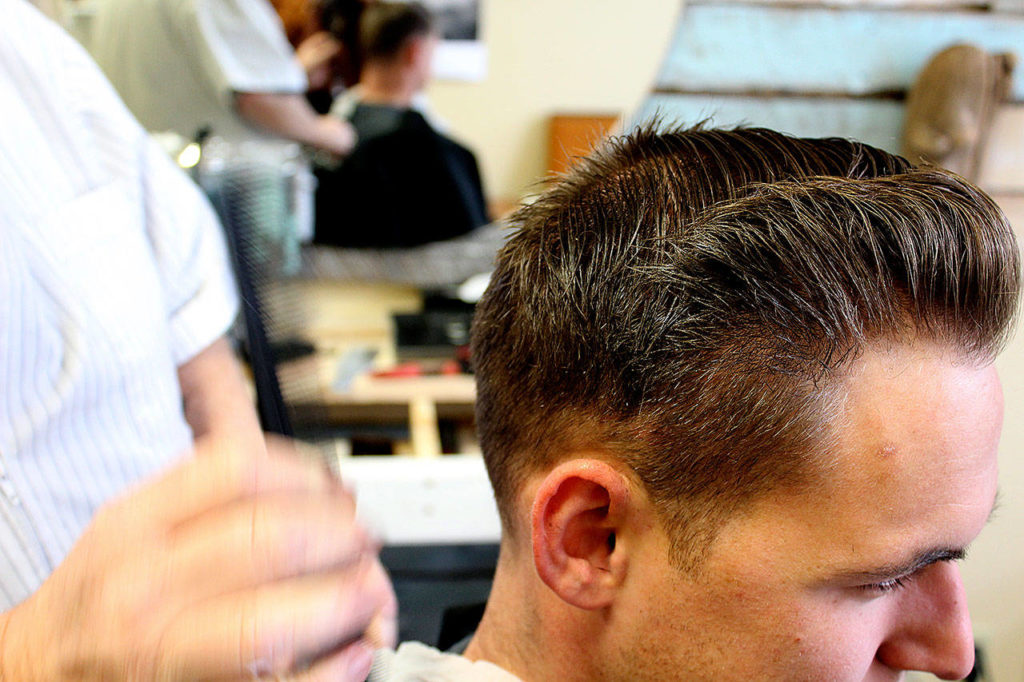 Bell specializes in fade haircuts favored by military members. He also creates “rockabilly” styles. (Photo by Patricia Guthrie/Whidbey News-Times)
