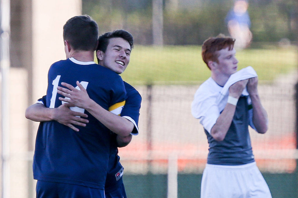 Glacier Peak’s Miles Johnston and Ryan Fey celebrates their 2-0 victory over Skyline in a 4A state playoff match on May 20, 2017, at Skyline High in Sammamish. (Kevin Clark / The Herald)

