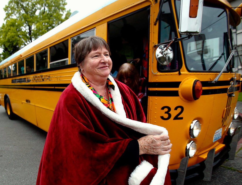 Cheffer steps off a vintage school bus after taking a spin in it, after also having been draped in a royal red cloak. (Dan Bates / The Herald)
