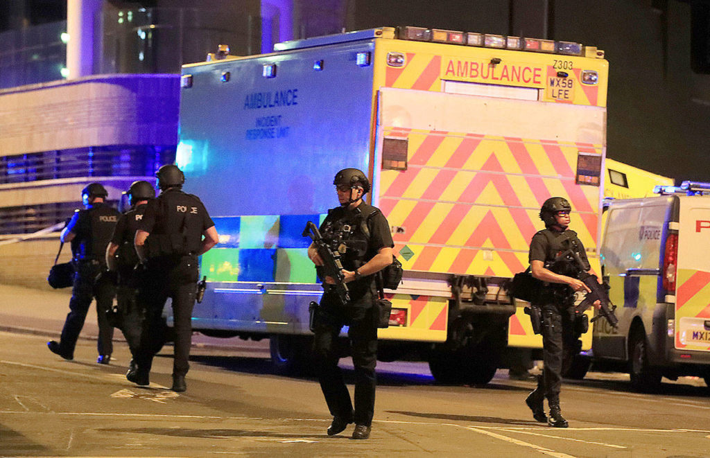 Armed police at Manchester Arena after reports of an explosion at the venue during an Ariana Grande concert in Manchester, England, on Monday. (Peter Byrne/PA)
