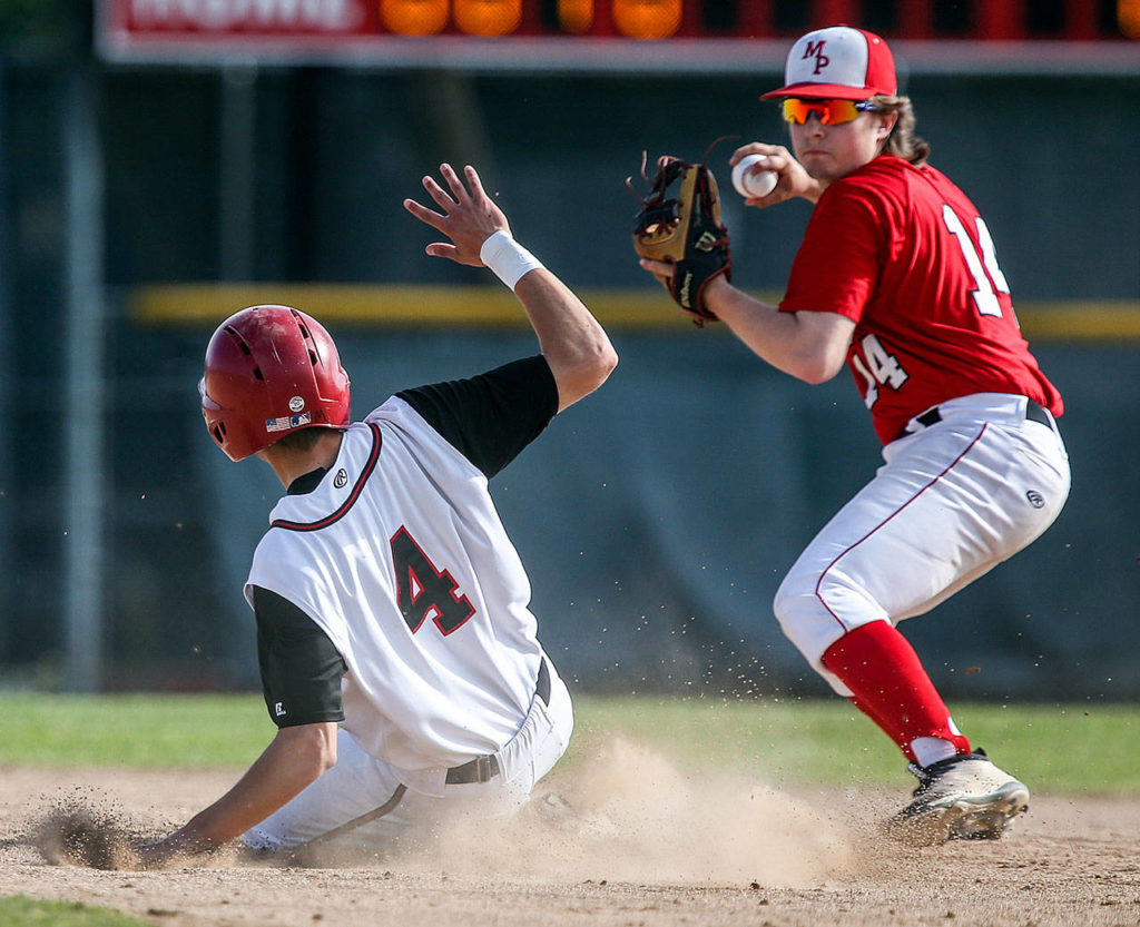 Snohomish’s Adam Ivelia (left) is forced out by Marysville Pilchuck’s Trevor Anderson in a winner-to-state, loser-out district game on May 10, 2017, at Earl Torgeson Field in Snohomish. (Kevin Clark / The Herald)
