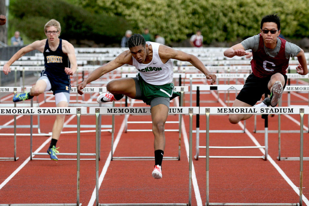 Everett’s Michael Neason (left), Jackson’s Theo Davis (center) and Cascade’s Shulong Mo (right) compete in the 110-meter hurdles at Memorial Stadium in Everett on May 5, 2017. (Kevin Clark / The Herald)
