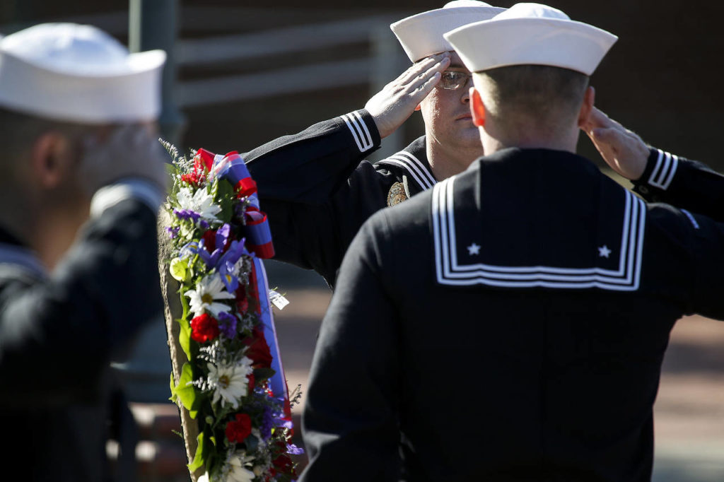 MA3 Steven Andrew Orick Jr. (center left) stands at attention during the wreath presentation at a ceremony held at Naval Station Everett on Thursday marking Memorial Day. (Ian Terry / The Herald)
