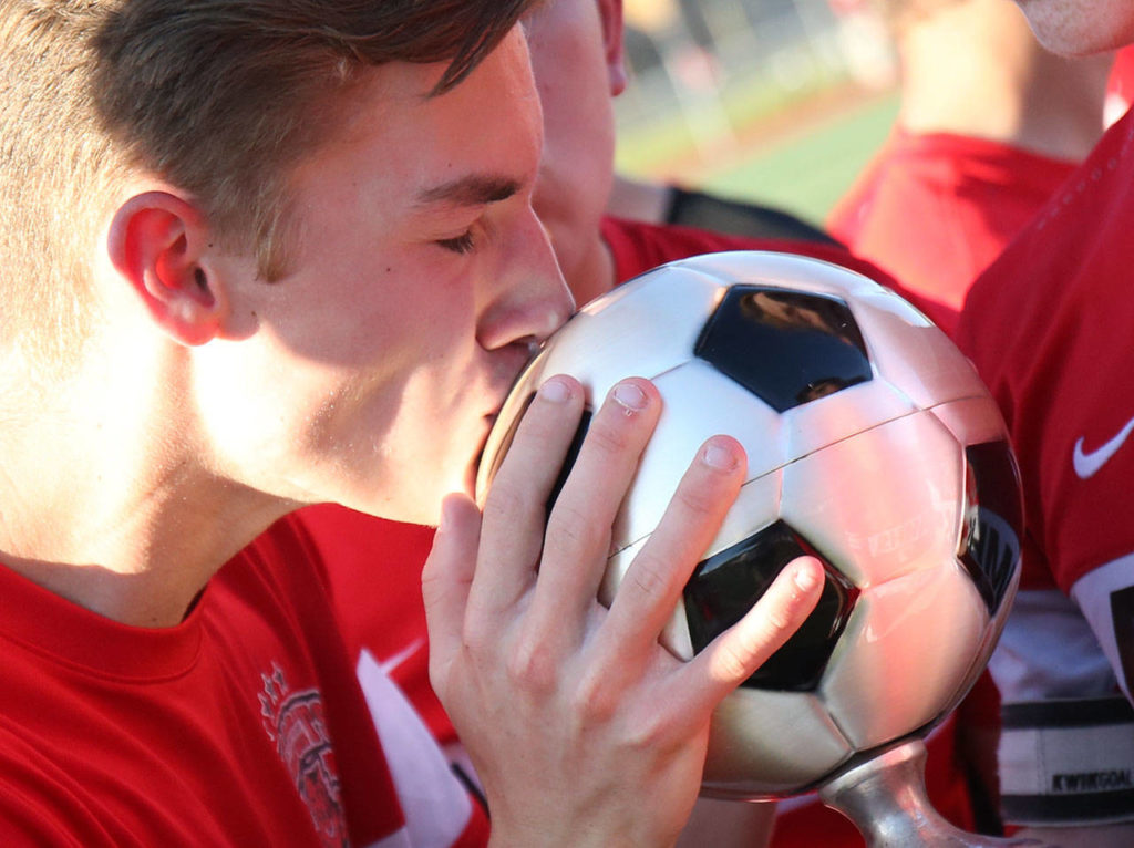 Archbishop Murphy’s Chase Whittaker kisses the trophy after beating East Valley in the 2A state soccer championship match on May 27, 2017, at Sunset Chev Stadium in Sumner. (Kevin Clark / The Herald)
