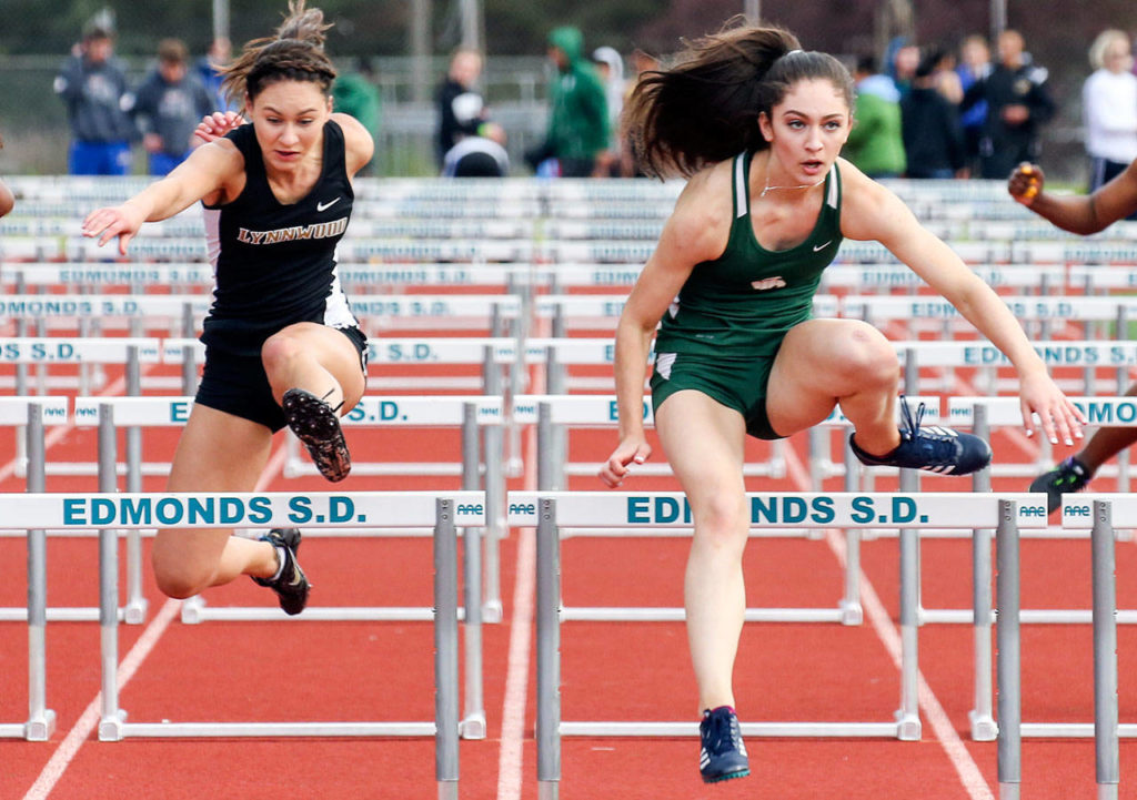 Shorecrest’s Marieke Visscher (right) takes first place over Lynnwood’s Rita Sakharov (left) in the 110-meter hurdles at the Wesco 3A South track and field championships on May 12, 2017, at Edmonds Stadium. (Kevin Clark / The Herald)
