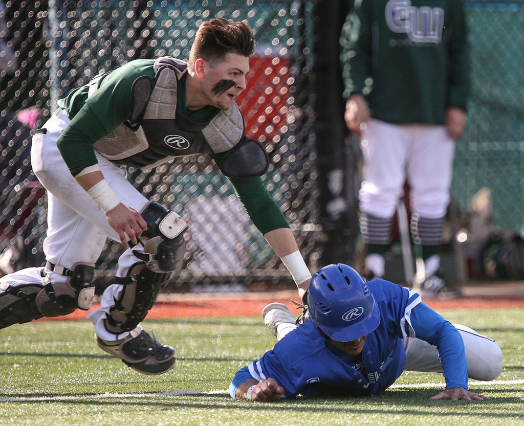 Edmonds-Woodway’s Kosta Cooper tags out Shorewood’s Arthur Pate to end a rundown Saturday during the 3A District 1 championship game in Shoreline. Edmonds-Woodway beat Shorewood 2-1. (Kevin Clark / The Herald)
