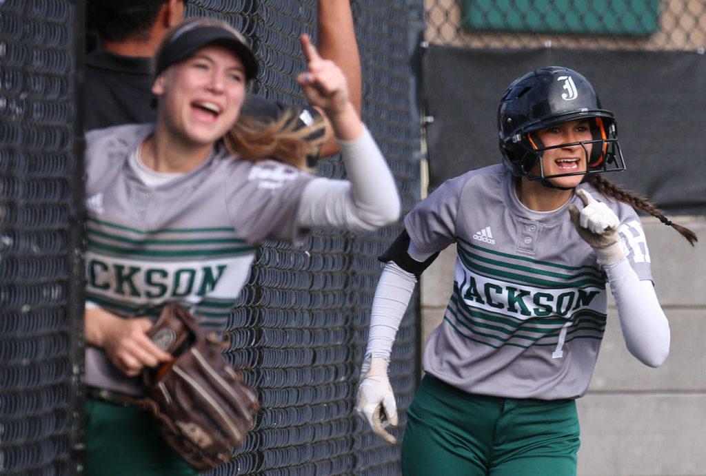 Jackson’s Kristina Day (left) and Braylin Jenson celebrate an RBI by Taylor Adams during the 4A district championship game against Lake Stevens on May 18, 2017, at Phil Johnson Ballfields in Everett. (Kevin Clark / The Herald)
