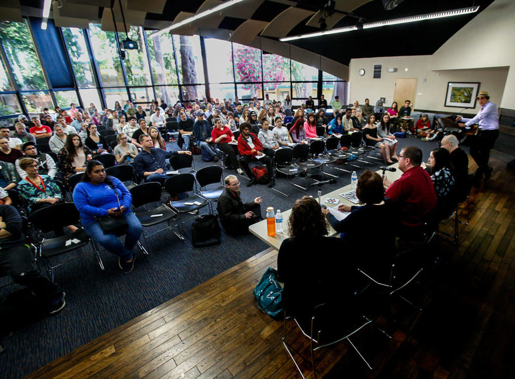 The Henry M. Jackson Center’s Wilderness Room was packed, Tuesday for the fake-news panel discussion with a half-dozen EvCC staff, including moderator Zaki Hamid (upper right). (Dan Bates / The Herald)
