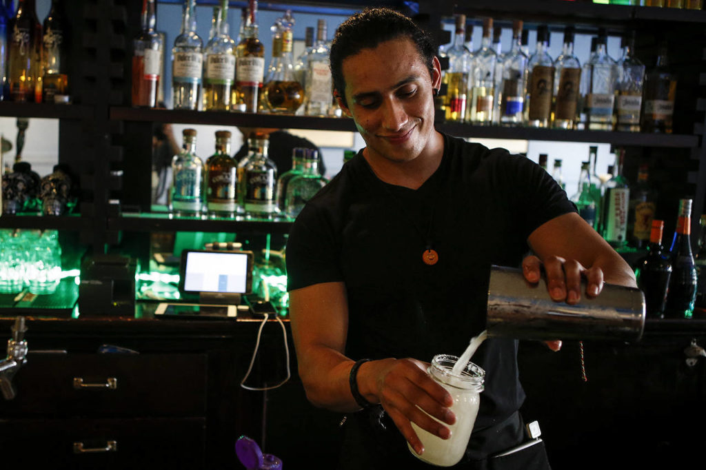 Bartender Christian Casanova serves up a margarita at Calle in downtown Mount Vernon. (Ian Terry / The Herald)
